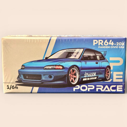 Model car kit packaging with blue car illustration on a beige and blue background