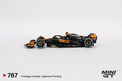 DiecastYard Mini GT McLaren MCL60 Lando Norris 2023 Japanese GP diecast model car in black and papaya orange